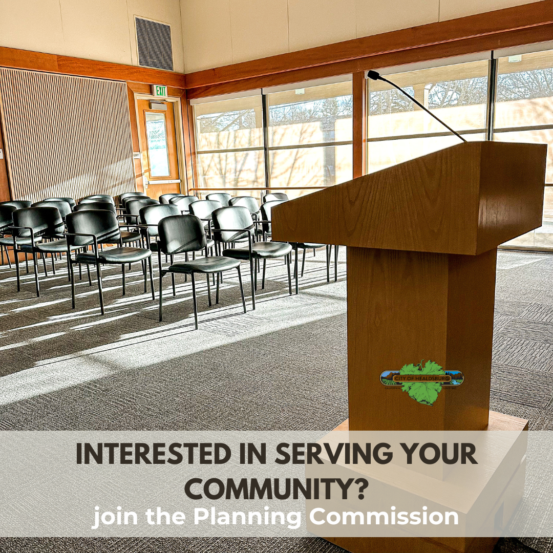 Empty Council Chamber with Black chairs and a brown podium with a microphone